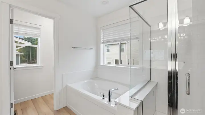 A peaceful spot to recharge — spacious soaking tub with serene upper-level views.