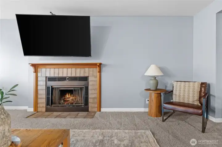 A nice wood fireplace adds a warm touch to the cozy living room