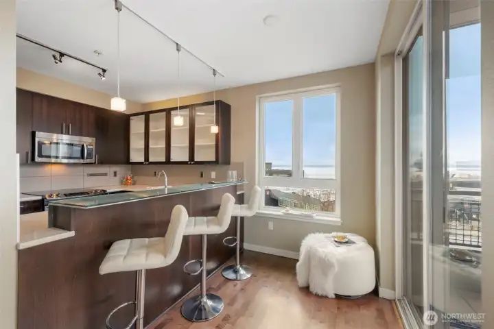 Stunning kitchen with breakfast bar, stainless appliances, stone counters and plenty of storage.