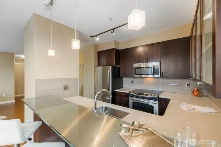 Stunning kitchen with breakfast bar, stainless appliances, stone counters and plenty of storage.