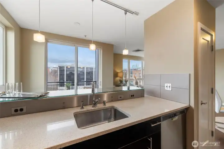 Stunning kitchen with breakfast bar, stainless appliances, stone counters and plenty of storage.