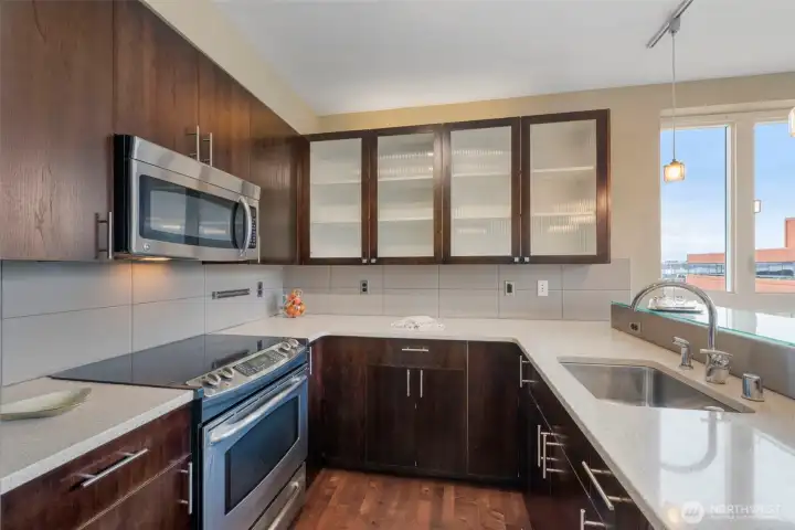 Stunning kitchen with breakfast bar, stainless appliances, stone counters and plenty of storage.