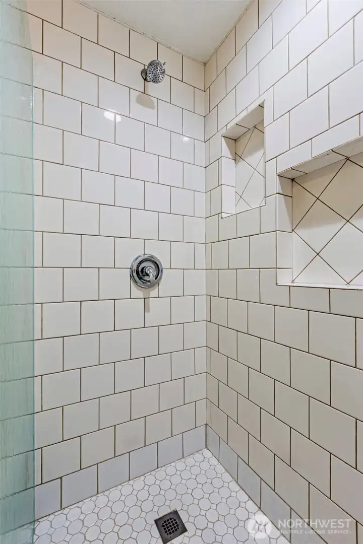 This bathroom boasts tile floor to ceiling.