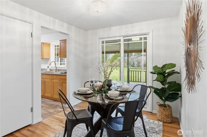 Gather here for meals, or enjoy the extended entertainment space on the covered deck outside. To the left is a coat closet.