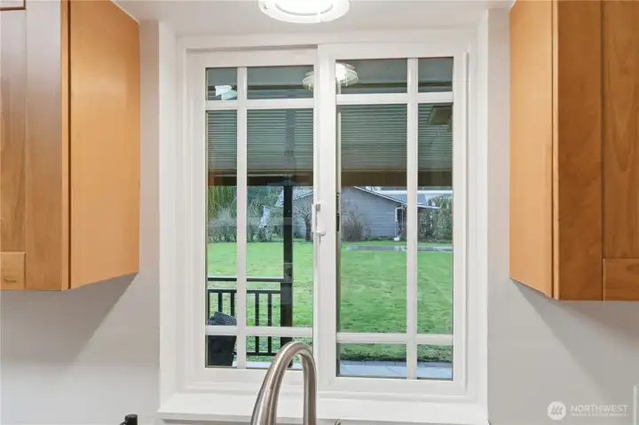 The kitchen window over the sink offers a view to the spacious, peaceful backyard.