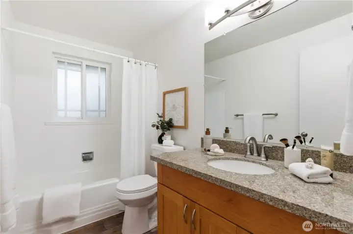A brand new vanity and countertop is just one of many updates in this bathroom. Enjoy the ample storage space in the cupboards below.