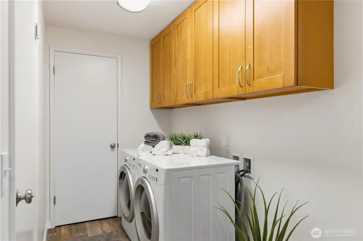 Near the interior garage entrance is this laundry area. The brand new cupboards above and the closet nearby, offer fantastic storage space.