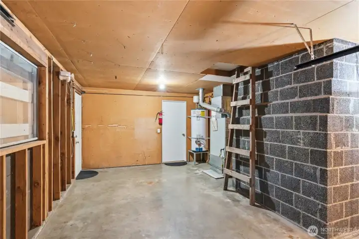 Additional storage in the attic above is accessible up the ladder. The door in the back left steps into the second garage.
