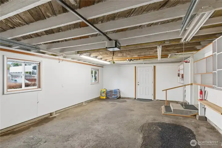 The door in the back accesses the backyard of the home. Tons of room here to make it your dream garage!