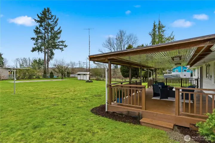 Circling around to the backyard, you'll find this generous, covered back deck. It has been recently painted.