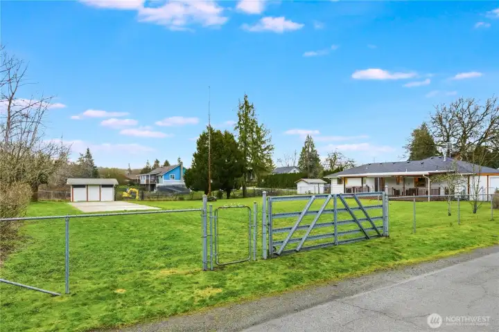 There is vehicle access to the oversized backyard and cement slab from the side street. Shown here is the gate for entry.