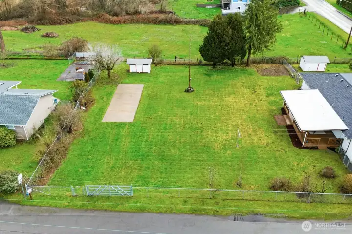 Looking east in this aerial view at the fenced backyard and property boundaries.