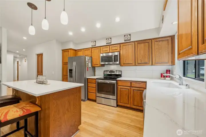 Kitchen featuring quartz countertops and a cozy island, combining style and functionality for everyday use.