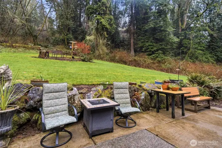 Patio area with space for outdoor seating, ideal for enjoying the private backyard setting.