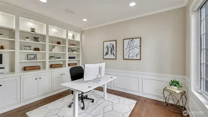 Spacious main floor den/office area with built-ins and large window creates an amazing sunlit flexible space.