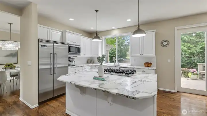 Dreamy marble surfaces and subway tile are the beginning of the upscale finishes in this spectacular kitchen.