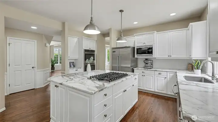 Abundant cabinetry and over-sized island with storage and seating for 3