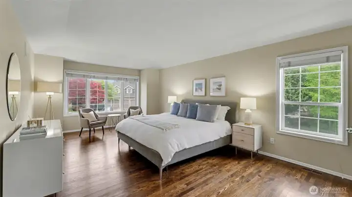 Expansive primary suite with large windows and in-wall speakers provides a well appointed, serene escape.