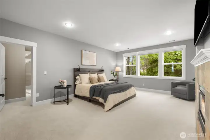 Massive primary bedroom overlooking the patio/deck area. Power blinds for your convenience.