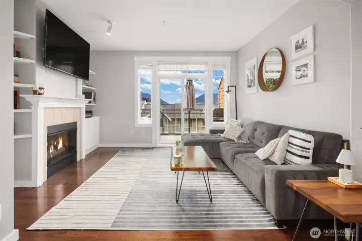 Living room with sliding glass opening to private deck.