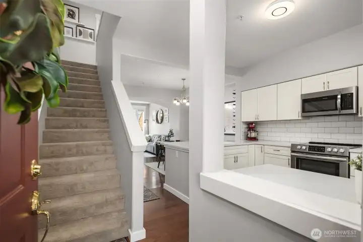 Entrance opens to kitchen with ample natural light.