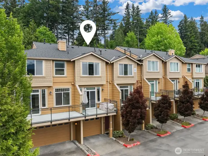 Exterior view showcasing private deck & garage.