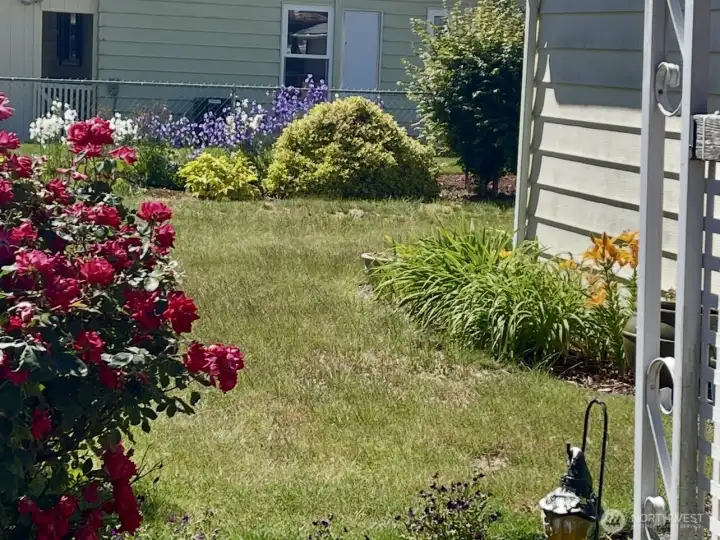 Fully fenced yard with beautifully landscaped garden.