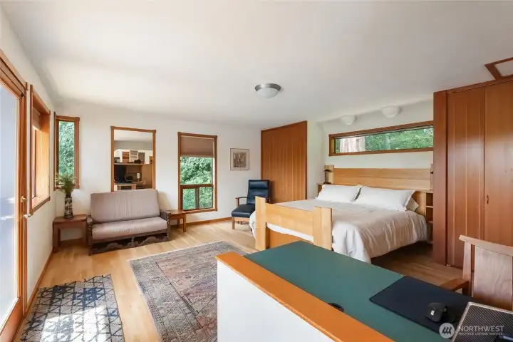 The primary bedroom space features a built-in bed, built-in desk, and double closets with built-in shelving and cabinets The primary bedroom space features a built-in bed, built-in desk, and double closets with built-in shelving and cabinets