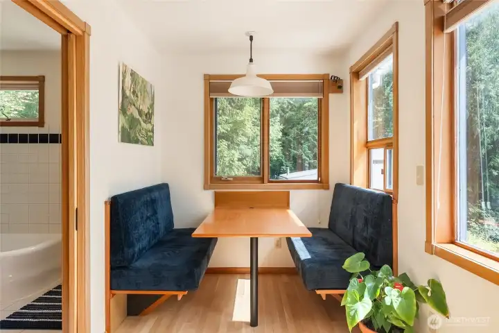 The kitchen features a built-in banquette for seating The kitchen features a built-in banquette for seating