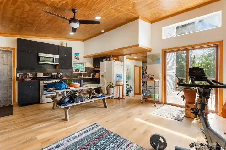 A large open living space, kitchen, and access to the west-facing deck A large open living space, kitchen, and access to the west-facing deck