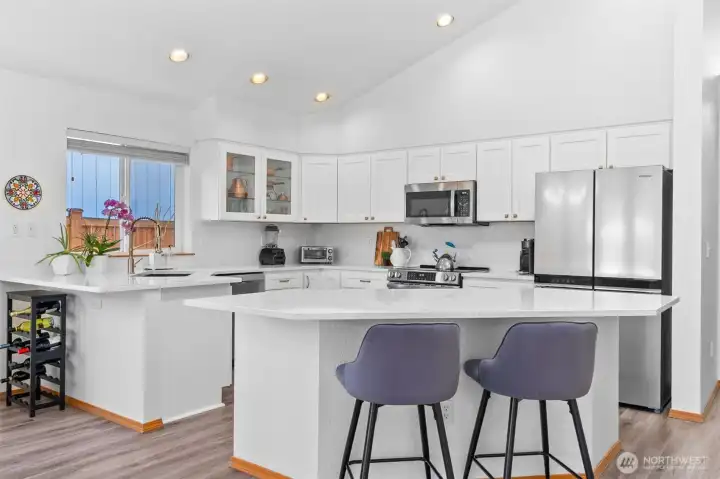 Kitchen remodeled with quartz counter tops, quartz backsplash, island, and stainless steel appliances Kitchen remodeled with quartz counter tops, quartz backsplash, island, and stainless steel appliances