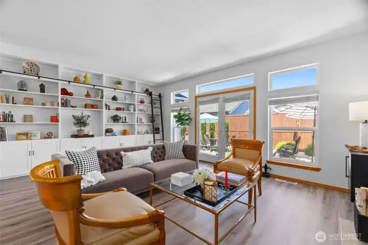Living room with built in cabinets, rolling ladder, gas fireplace, and so many windows! Living room with built in cabinets, rolling ladder, gas fireplace, and so many windows!