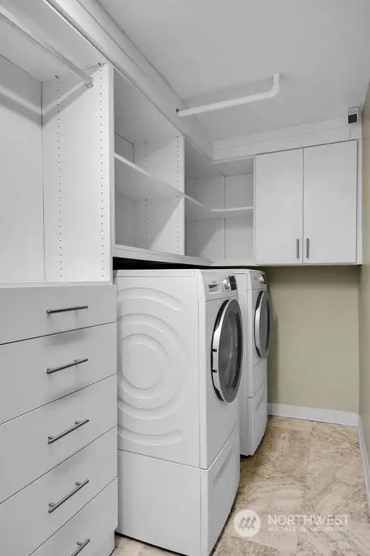Laundry room with CA closet built-ins.