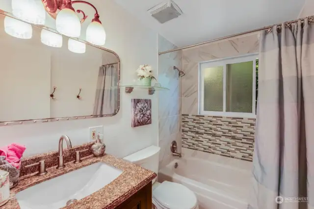 Bathroom with tile shower and floor