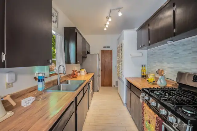 Kitchen with tile flooring and Stainless-Steel fridge and stove