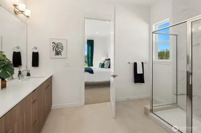 Dual vanity bathroom with tile shower