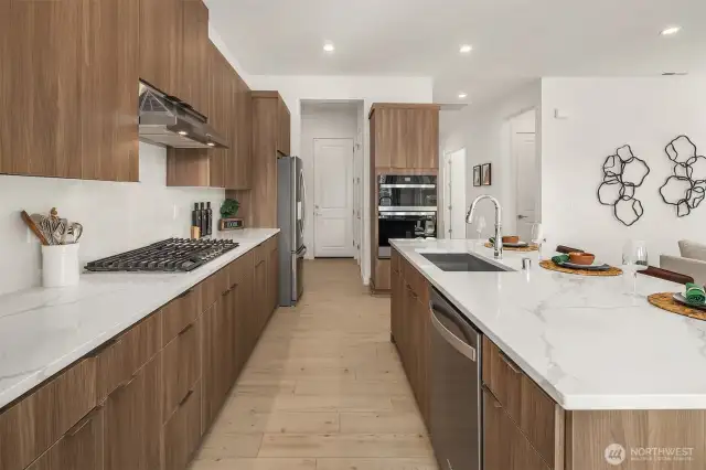 Modern cabinet and light quartz countertops, gas cooktop