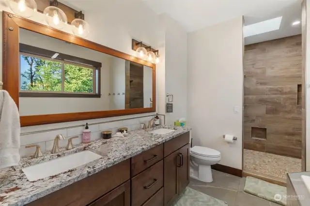 In the master bath, benefit from the soaking tub, views and walk-in stone shower with double heads.