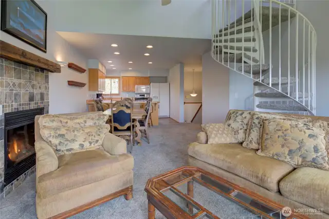 Turning back to the front side of the home, we see the dining area, kitchen, front entry, and hall leading to the secondary bedroom and main bath.
