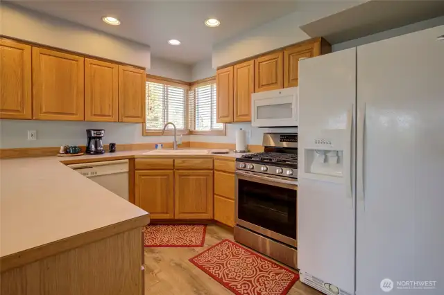 Kitchen sink looks out towards the front of the property, and there is a propane gas stove/range.