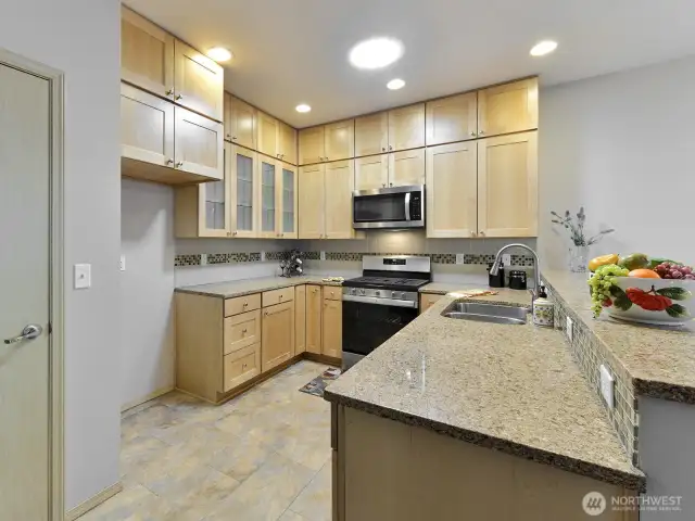 Granite countertops. and Upgraded to ceiling cabinets. Pantry,  Stainless sink. Gas stainless stove. Tile Backsplash.
