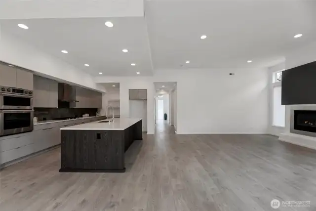View from the dining room of the kitchen, great room and the hallway to the entry