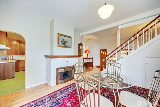 Dining room with fireplace, viewing the stairs to the primary bedroom and entrance
