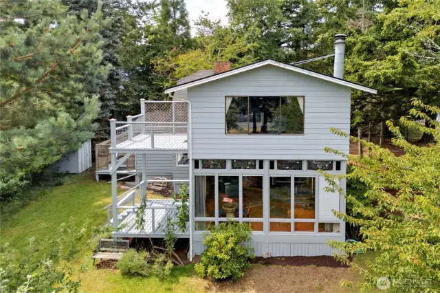 Good view of the sunroom on the main floor and primary bedroom above, both with decks to the view and south facing.