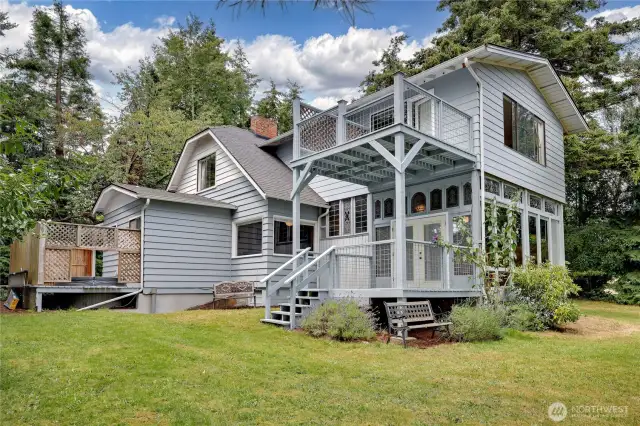 Decks off the sunroom and primary bedroom and private deck with hot tub.