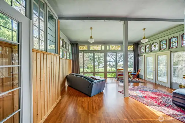 Sunroom with the 17 antique French and German stained-glass windows.