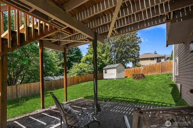 Under deck patio area and yard with shed