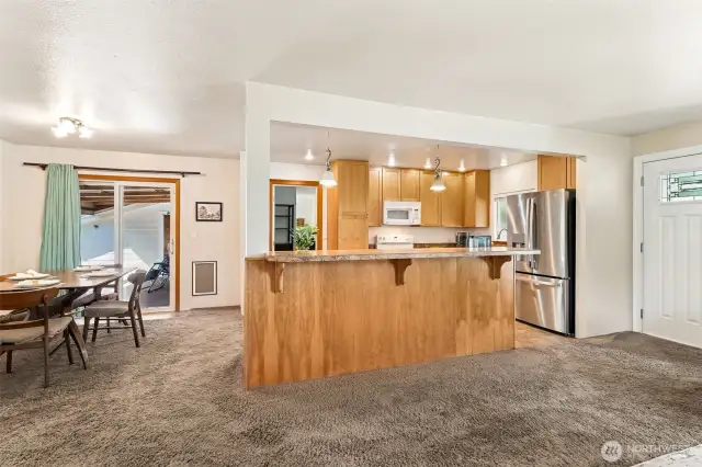Nice size kitchen with room for bar seating and dining table.