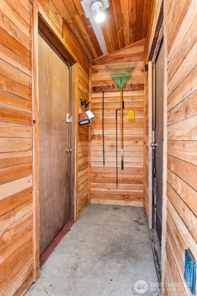 Storage shed to the left and garage access to the right.