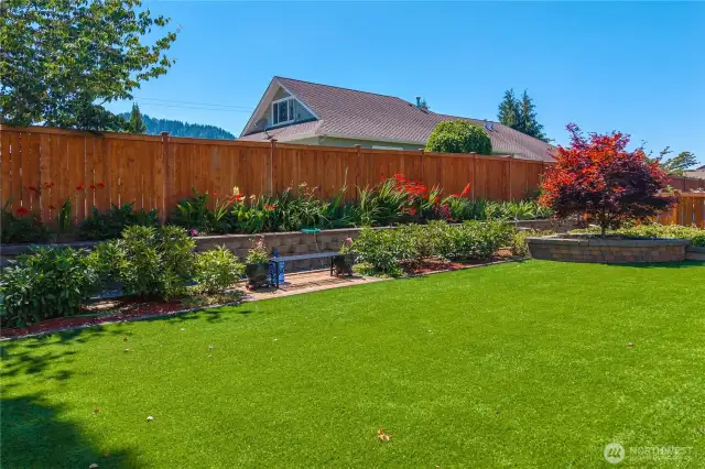 Raised beds with colorful flowers and shrubs.